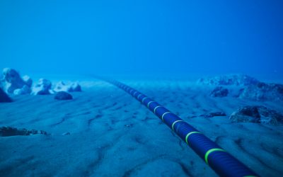 Underwater fiber-optic cable on ocean floor.